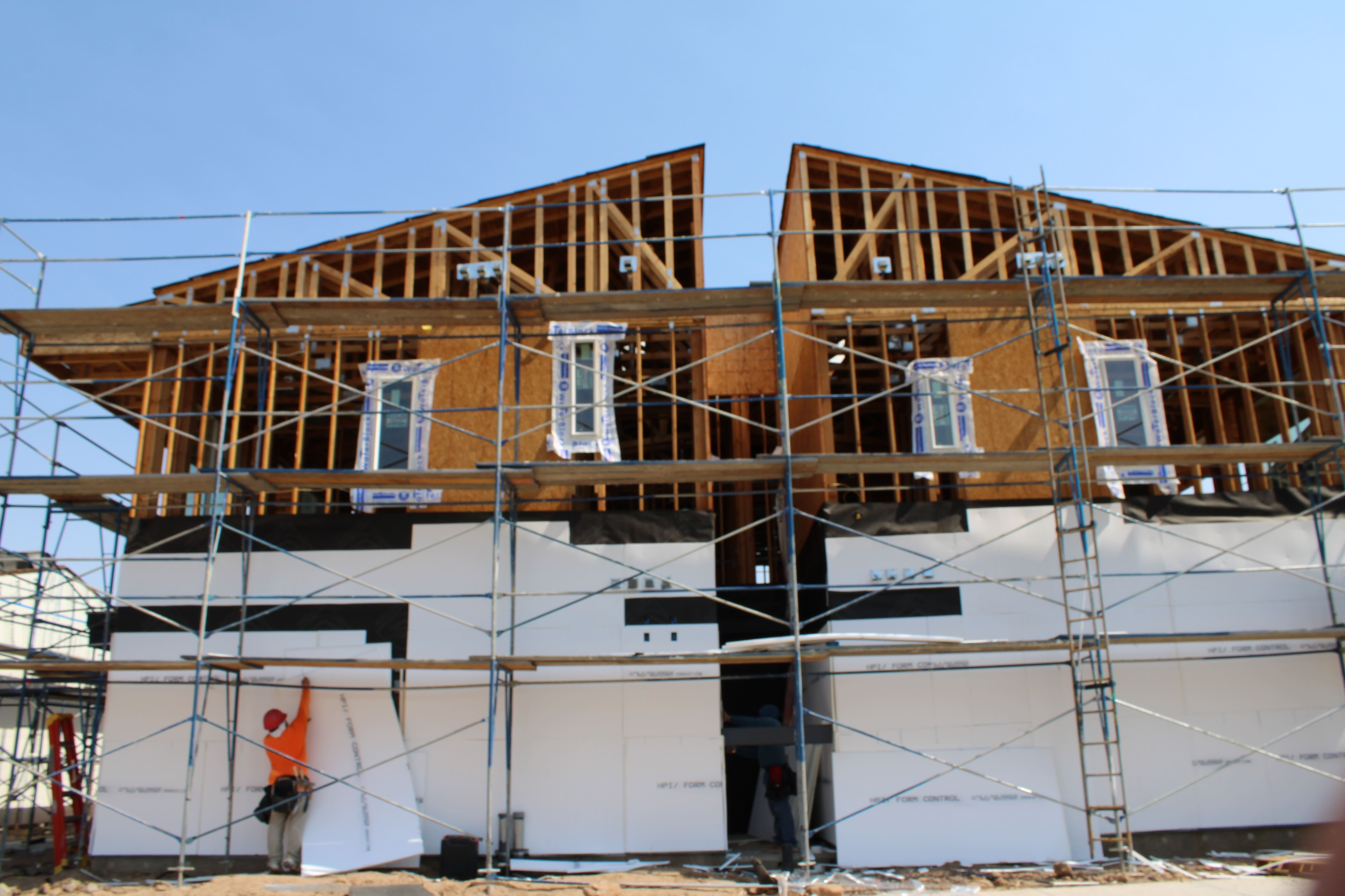 Team reviewing blueprints on a wooden table